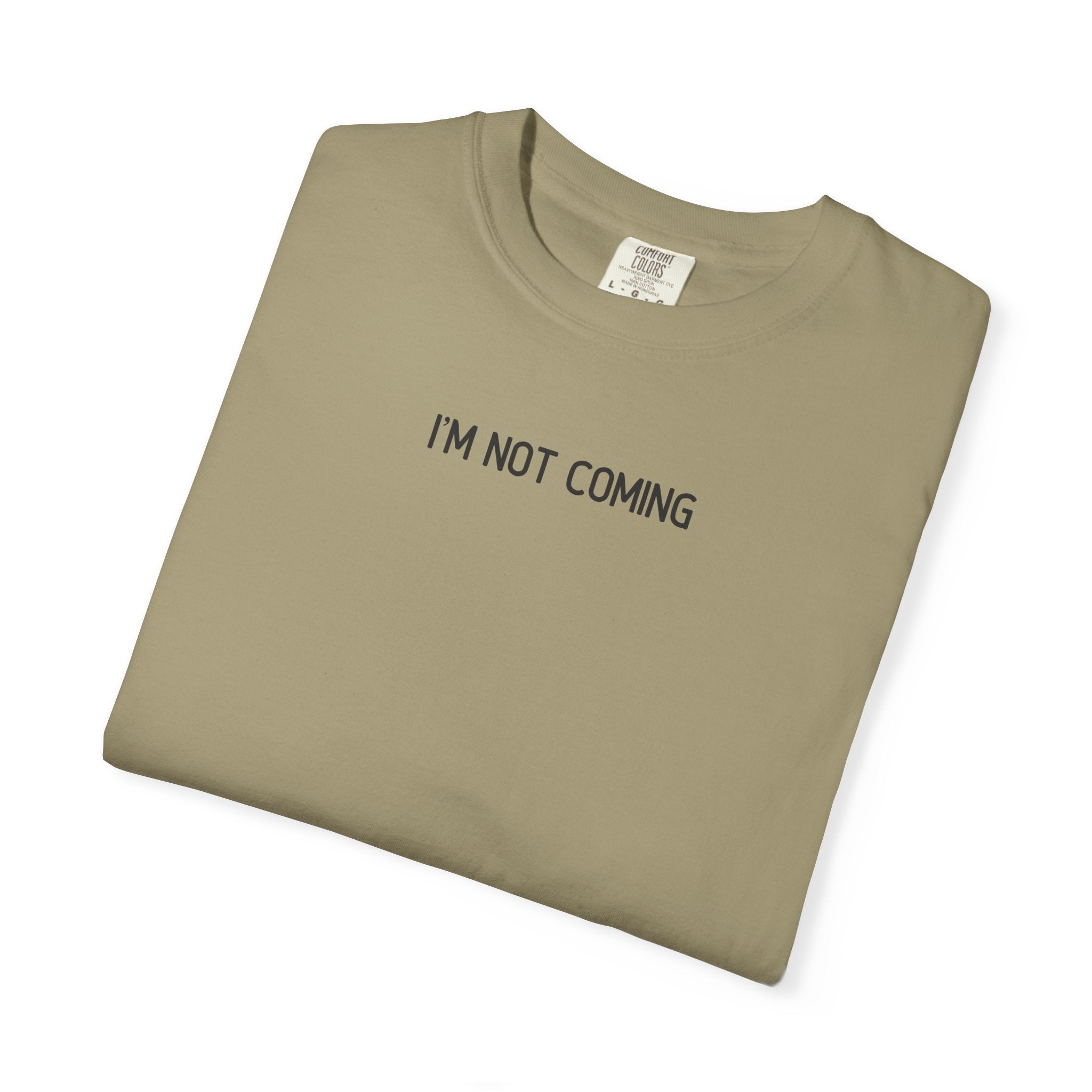 Folded khaki t-shirt with 'I'M NOT COMING' text on a white background