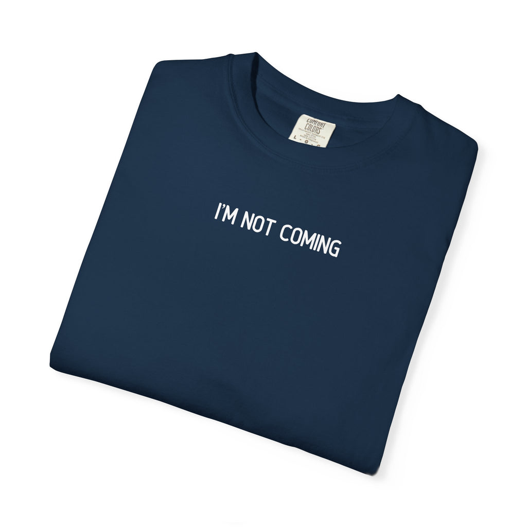 Folded navy blue t-shirt with 'I'M NOT COMING' text on a white background