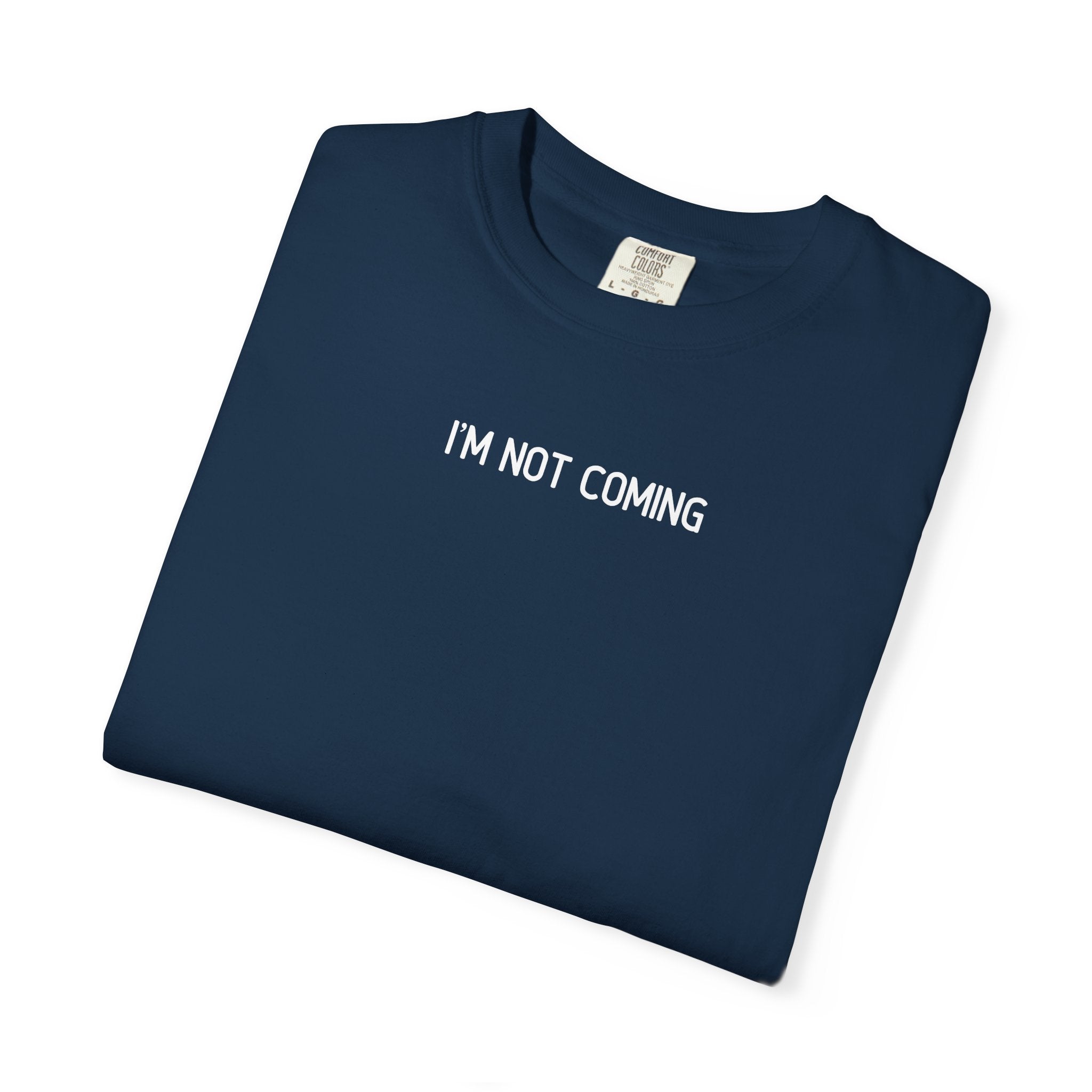 Folded navy blue t-shirt with 'I'M NOT COMING' text on a white background